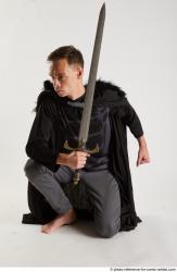 Man Adult Athletic White Fighting with sword Kneeling poses Coat
